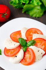 Tomato and mozzarella with basil leaves