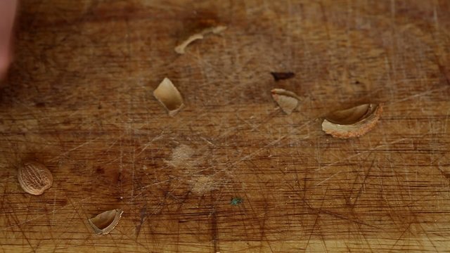 Broken peach stone with hammer