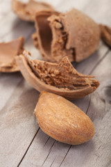 .almond with its shell on a wooden table
