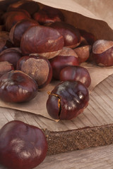 pile of chestnuts on a wooden table