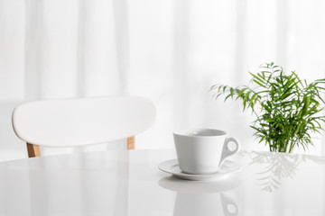 White cup on the kitchen table