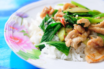 Kale vegetable with porky on rice.