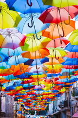 Fototapeta na wymiar Street decorated with colored umbrellas.
