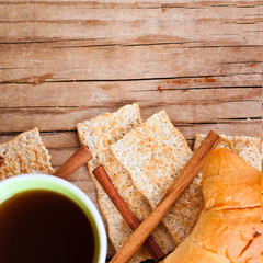 cup of coffee, crackers and fresh croissant for breakfast
