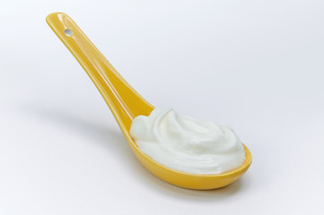 Sour cream in spoon - obrazy, fototapety, plakaty