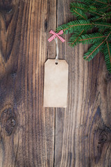 Pine tree with empty label on old wooden background