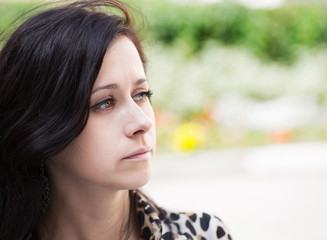 Obraz premium Portrait of a beautiful brunette on natural background.