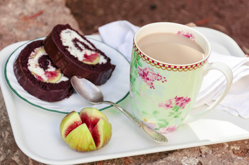 Milk Coffee, Chocolate fig roll and fig on a tray in the garden