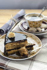 Piece of chocolate caramel cake and cup of coffee