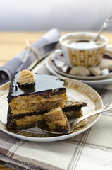 Piece of chocolate caramel cake and cup of coffee