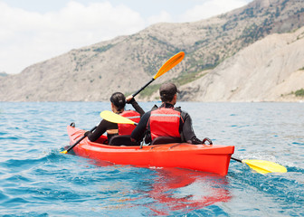 Fototapeta na wymiar Young couple in a sea kayak.