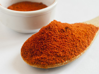 Paprika ground in a white bowl on white background