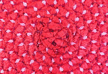 Close view of a woven red straw hat