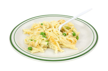 A serving of linguine with peas on a plate with a fork