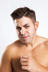 Fototapeta premium expression of a young fit man in white background