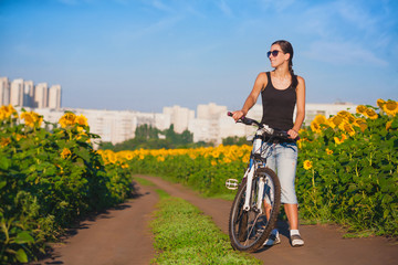 cyclist in a sunflower's field on a bike. travel