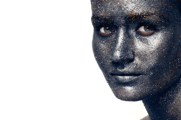 Beautiful face of a woman covered in glitter