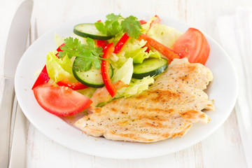 grilled turkey with salad on plate