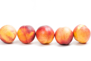 Ripe peaches fruits isolated on white