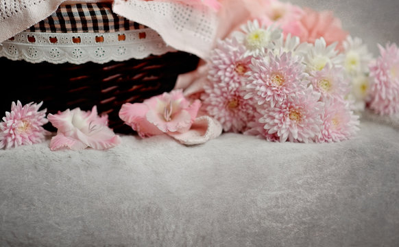 brown wicker basket with delicate pink chrysanthemums