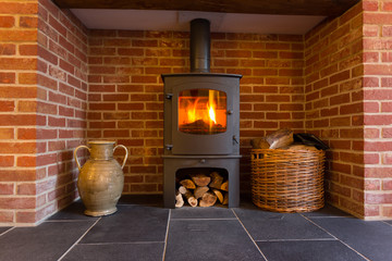Fototapety  Wood burning stove in brick fireplace