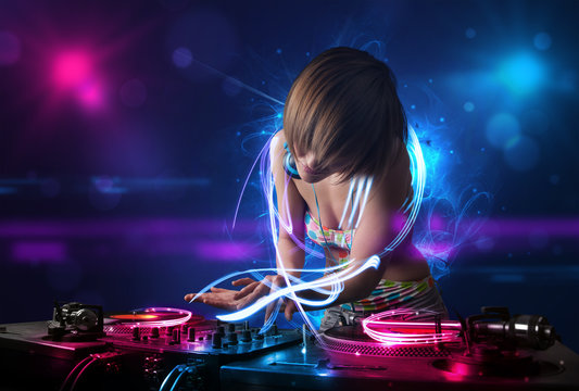 Disc jockey playing music with electro light effects and lights