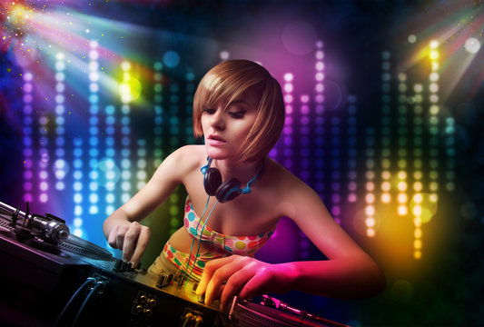 Dj girl playing songs in a disco with light show
