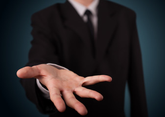 Obraz premium Handsome business man presenting with hand copy space