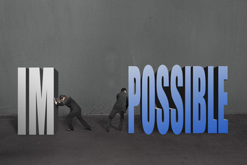 Two businessmen separate word "impossible" to IM and POSSIBLE, t