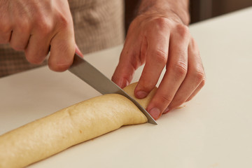 Baker cutting brioche dough