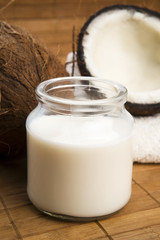 coconut fruit with a jar filled with coco milk