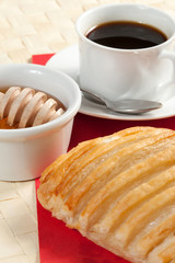 Breakfast including coffee, bread, honey.