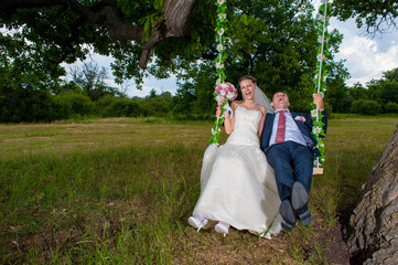 Groom and  bride  on swing