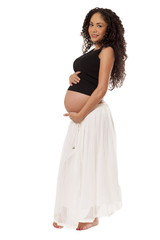 A pregnant woman cradles her protruding baby bump.