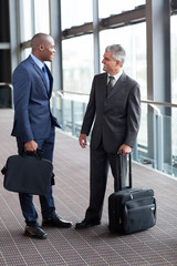 businessmen talking at airport