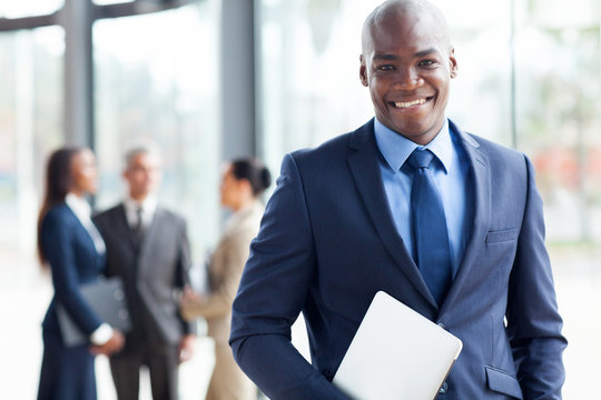 african american businessman with laptop computer in office