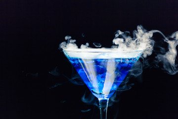 blue cocktail with splash and ice vapor