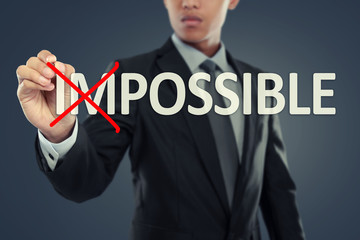 Businessman changing word impossible into possible