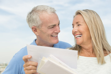 Woman With Mails Looking At Man Against Sky