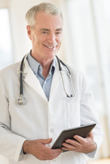 Confident Doctor With Digital Tablet At Clinic