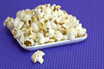 Popcorn plate on blue background