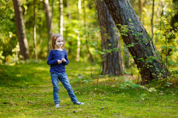 Adorable girl hiking in the forest on autumn day