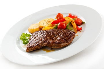 Grilled beefsteak, baked potatoes and vegetables