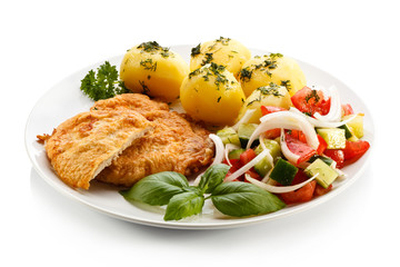 Fried pork chops, boiled potatoes and vegetable salad