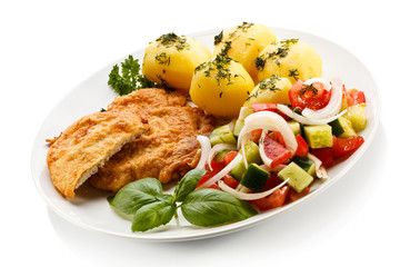 Fried pork chops, boiled potatoes and vegetable salad