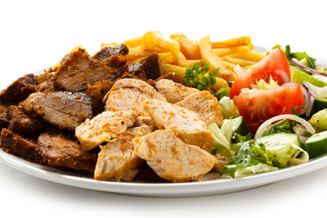 Grilled meat with French fries and vegetables