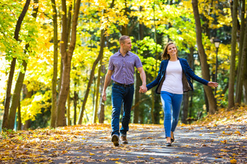 Urban leisure - woman and man walking in park