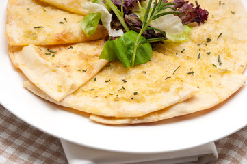 garlic pita bread pizza with salad on top