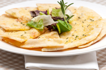 garlic pita bread pizza with salad on top