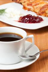 Light meal with coffee, bread and jam.